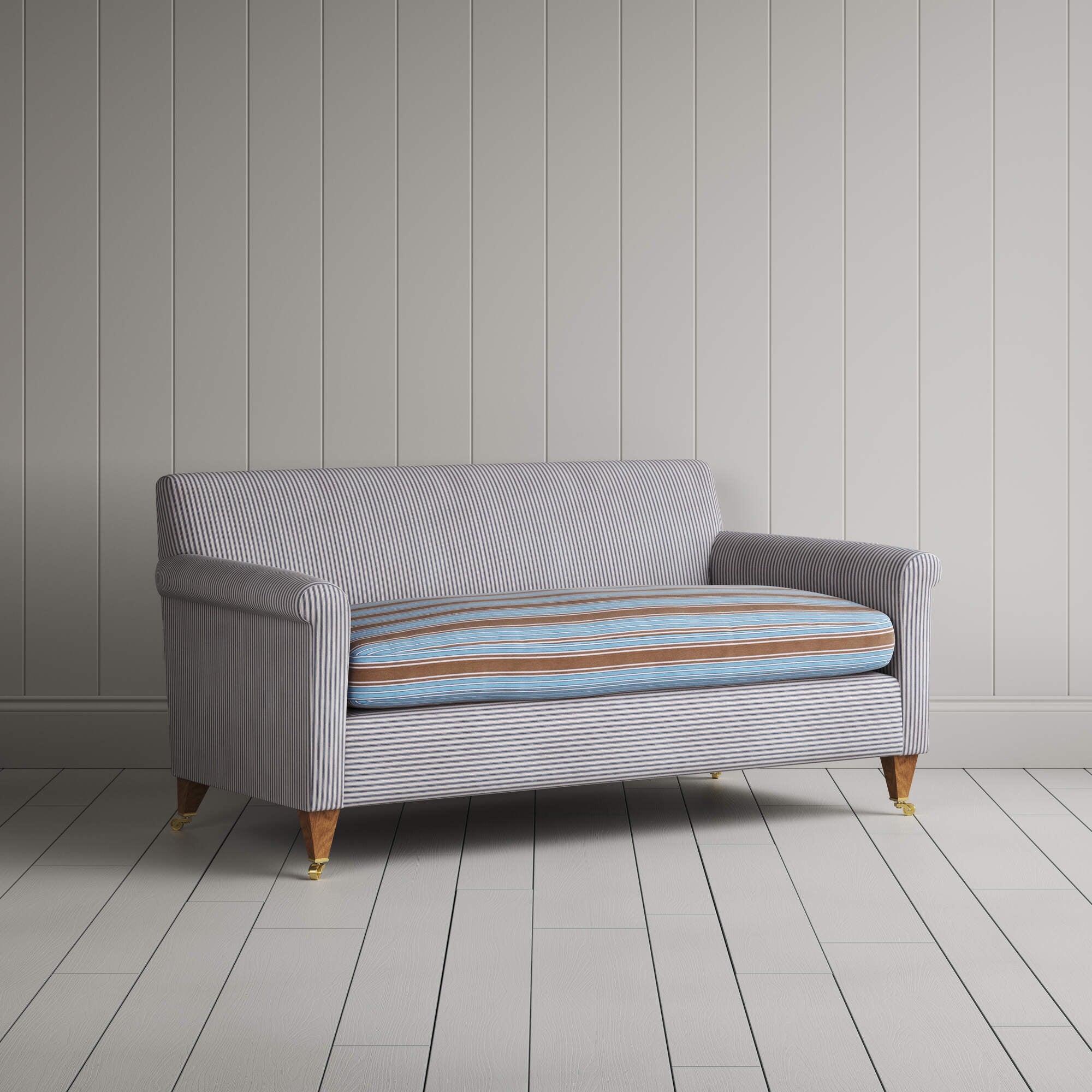 Angled view of the Ticking Blue Brown Idler sofa by NiX
