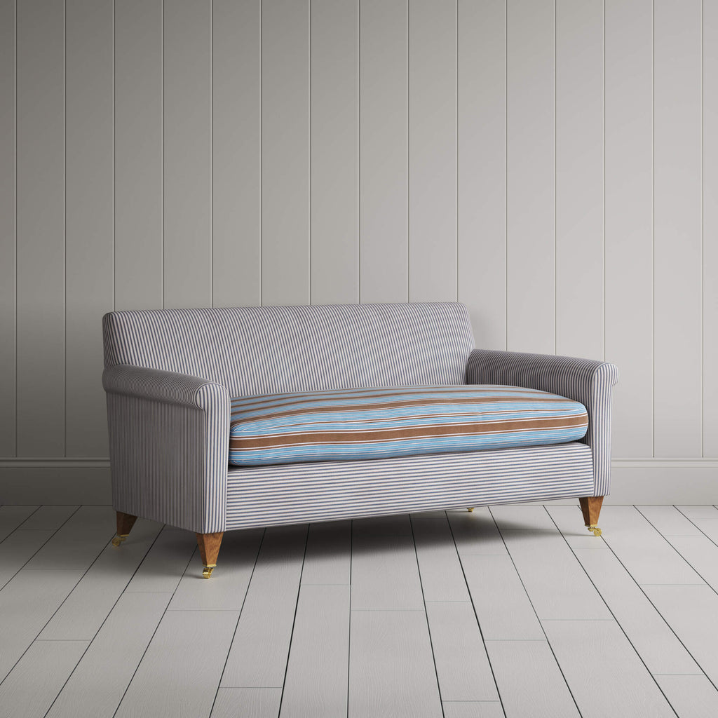 Angled view of the Ticking Blue Brown Idler sofa by NiX