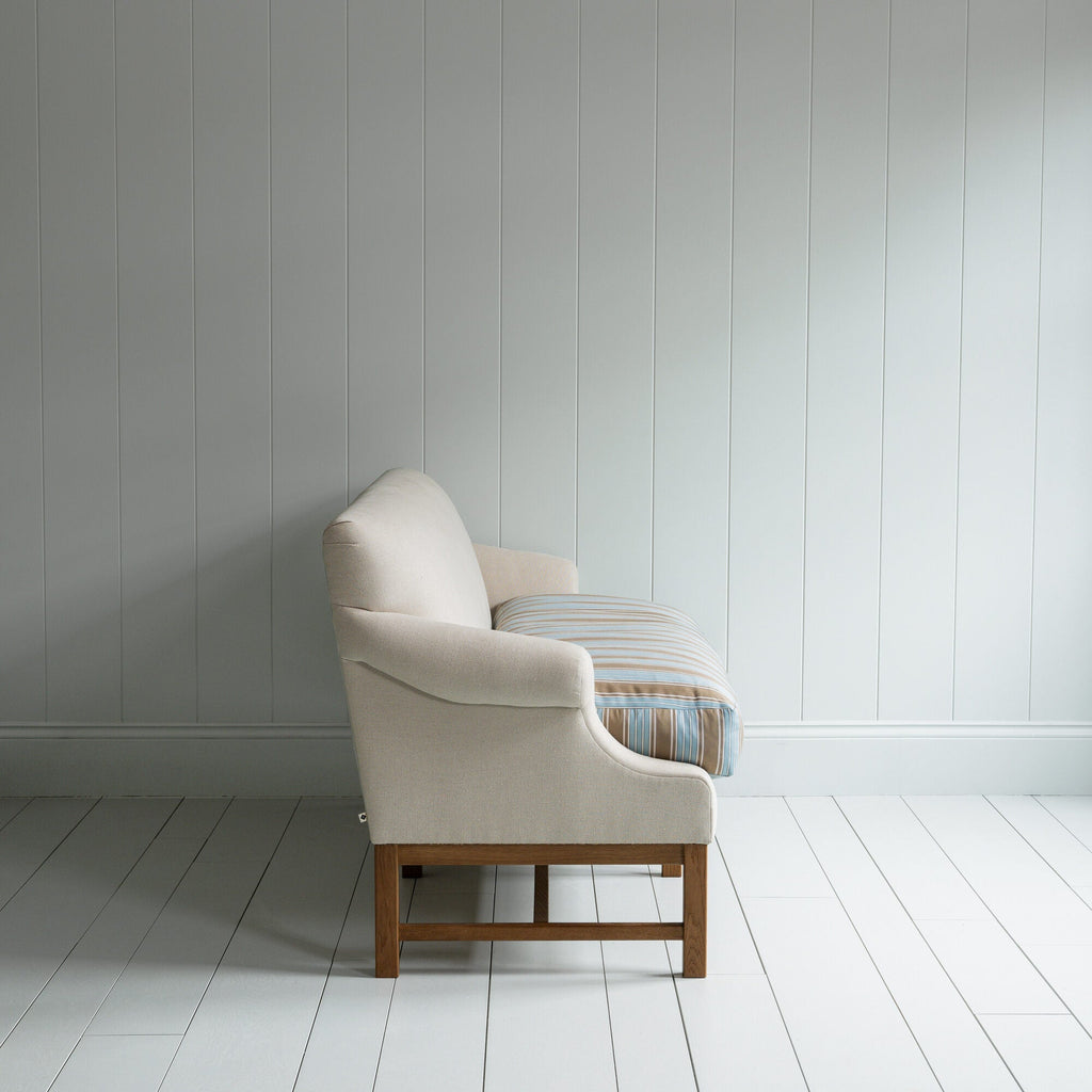 Side View of Front Row 3 Seater Upholstered Bench in Laidback Linen Dove Frame and Regatta Cotton Blue Seat - By Nicola Harding & Co.