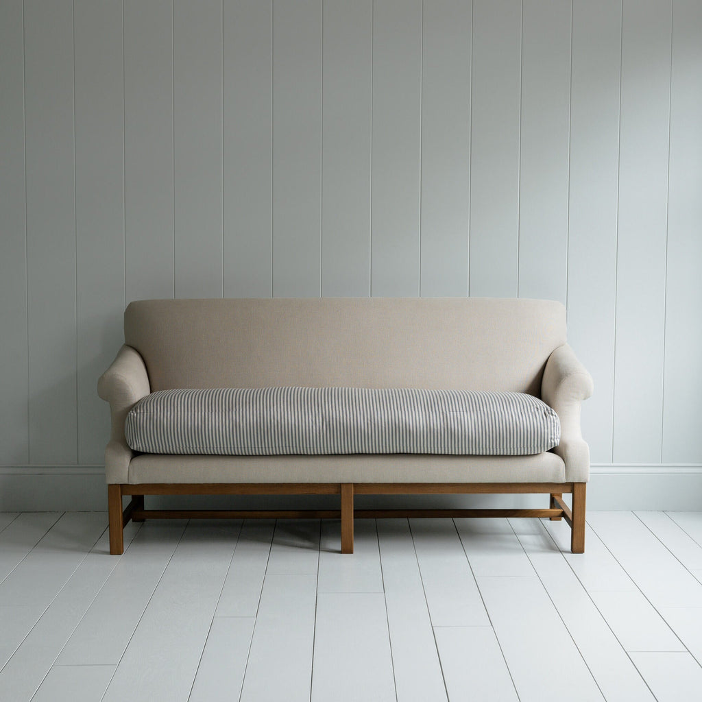 White couch on wooden floor in minimalist living room.