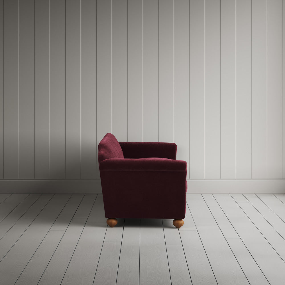 Side profile of the Cherry red corduroy Dolittle sofa