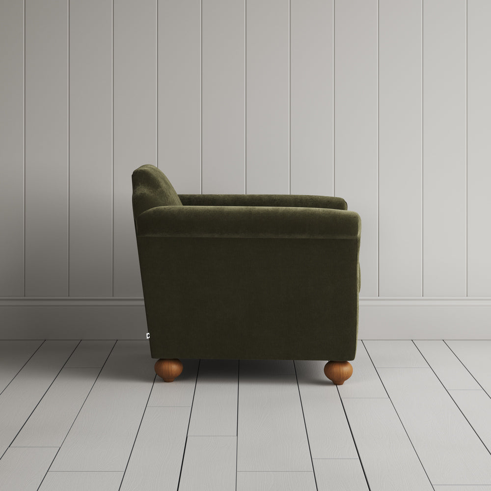 Side profile of the Caper green corduroy Dolittle armchair