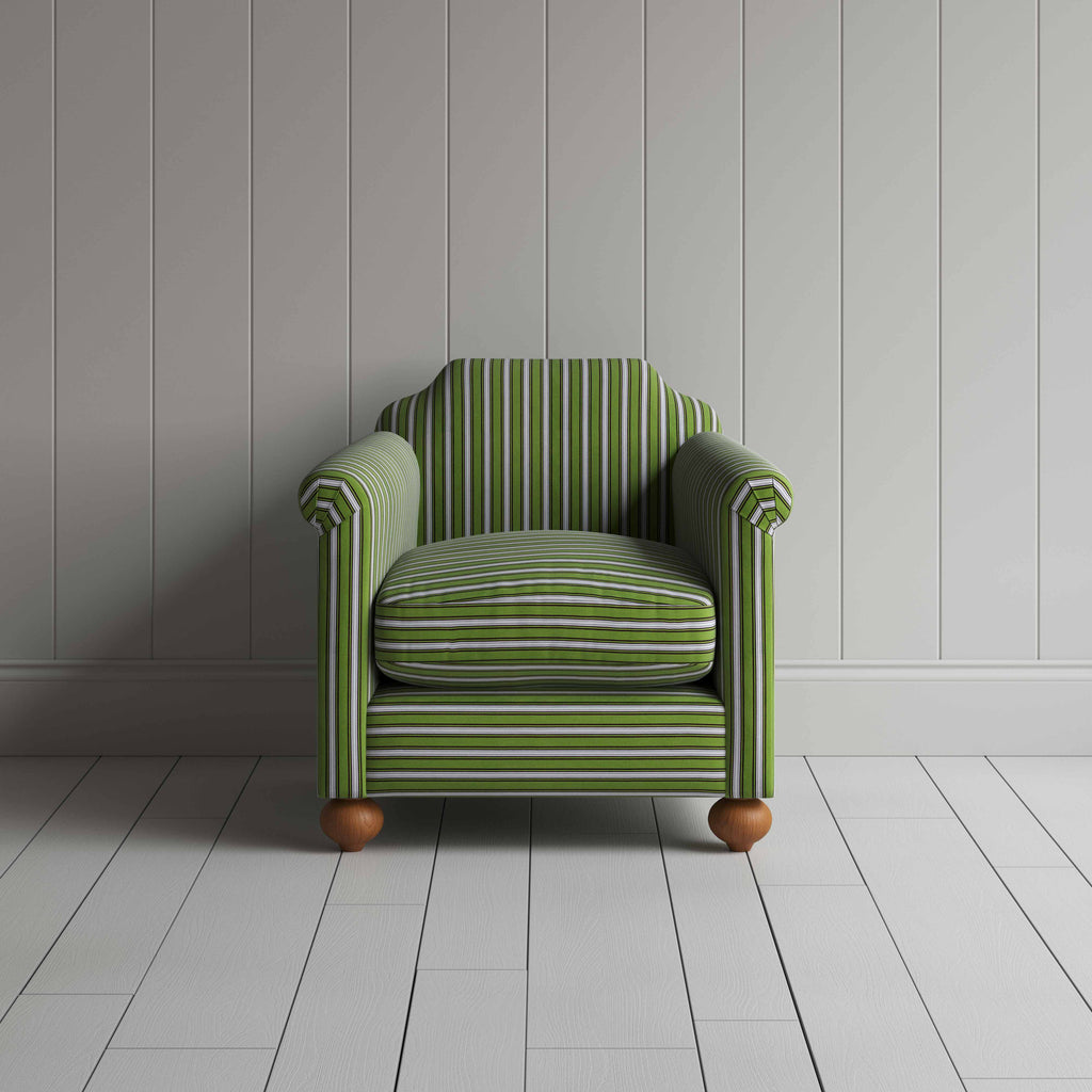 Green and white striped sofa in a spacious room with minimalistic decor.