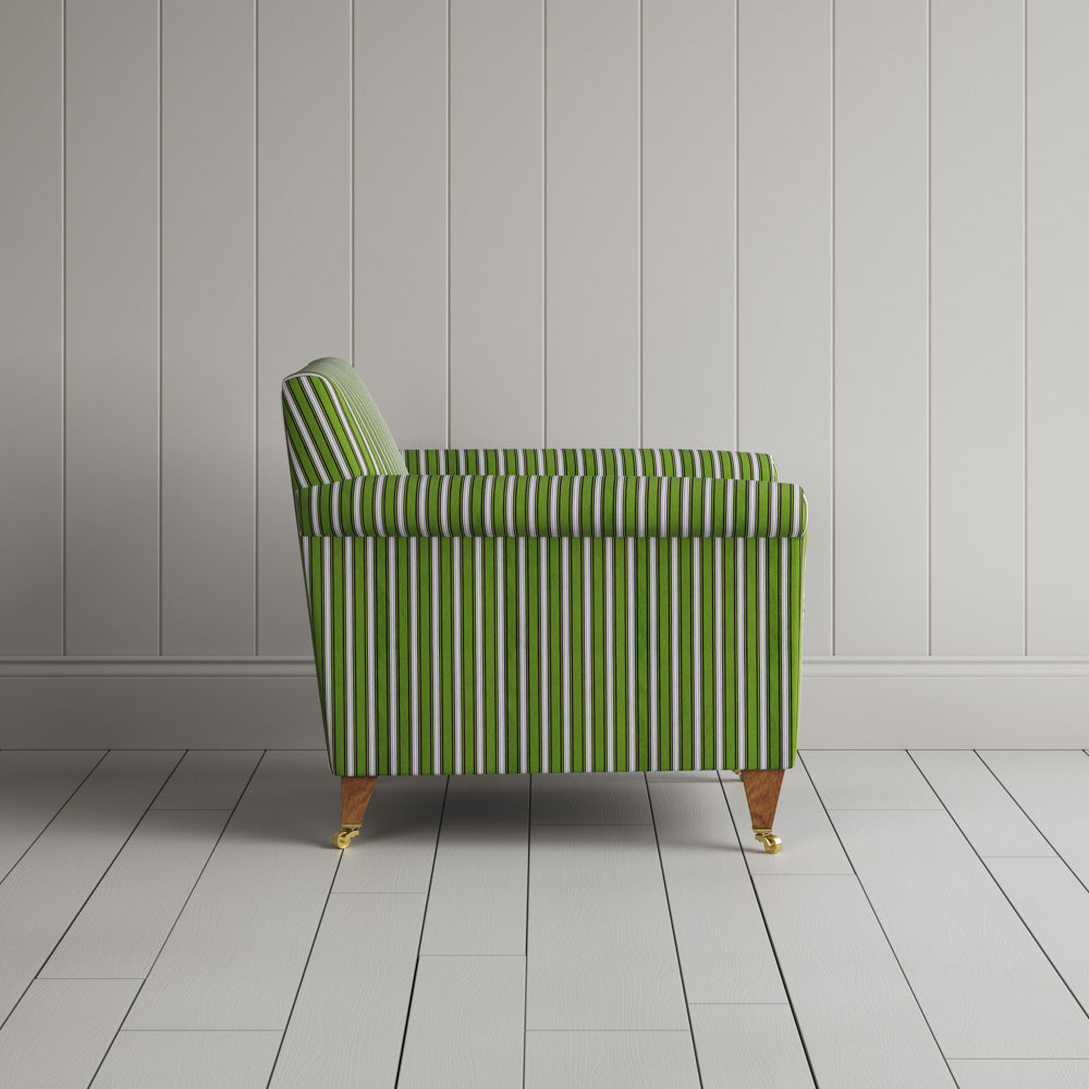 Striped green and white couch by a wall.