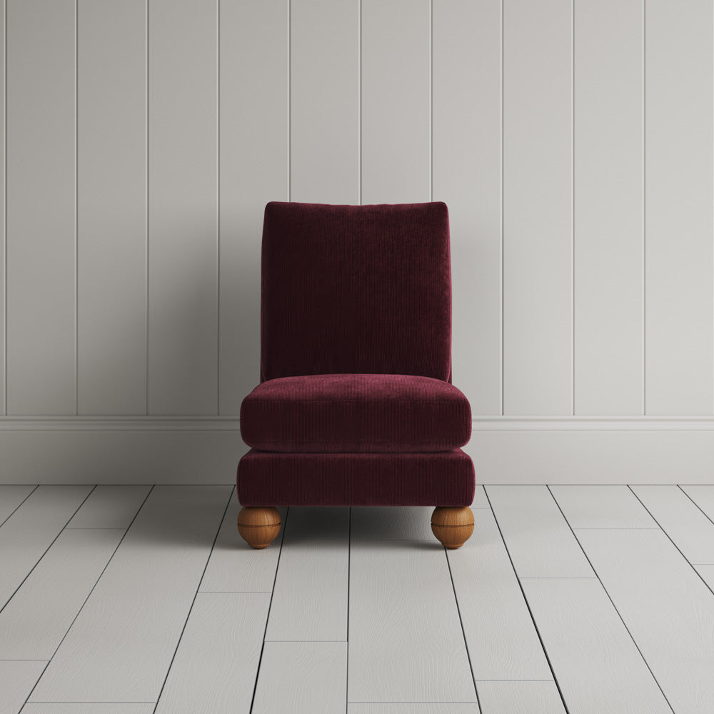 NiX furniture compact slipper chair with spherical feet, front view.