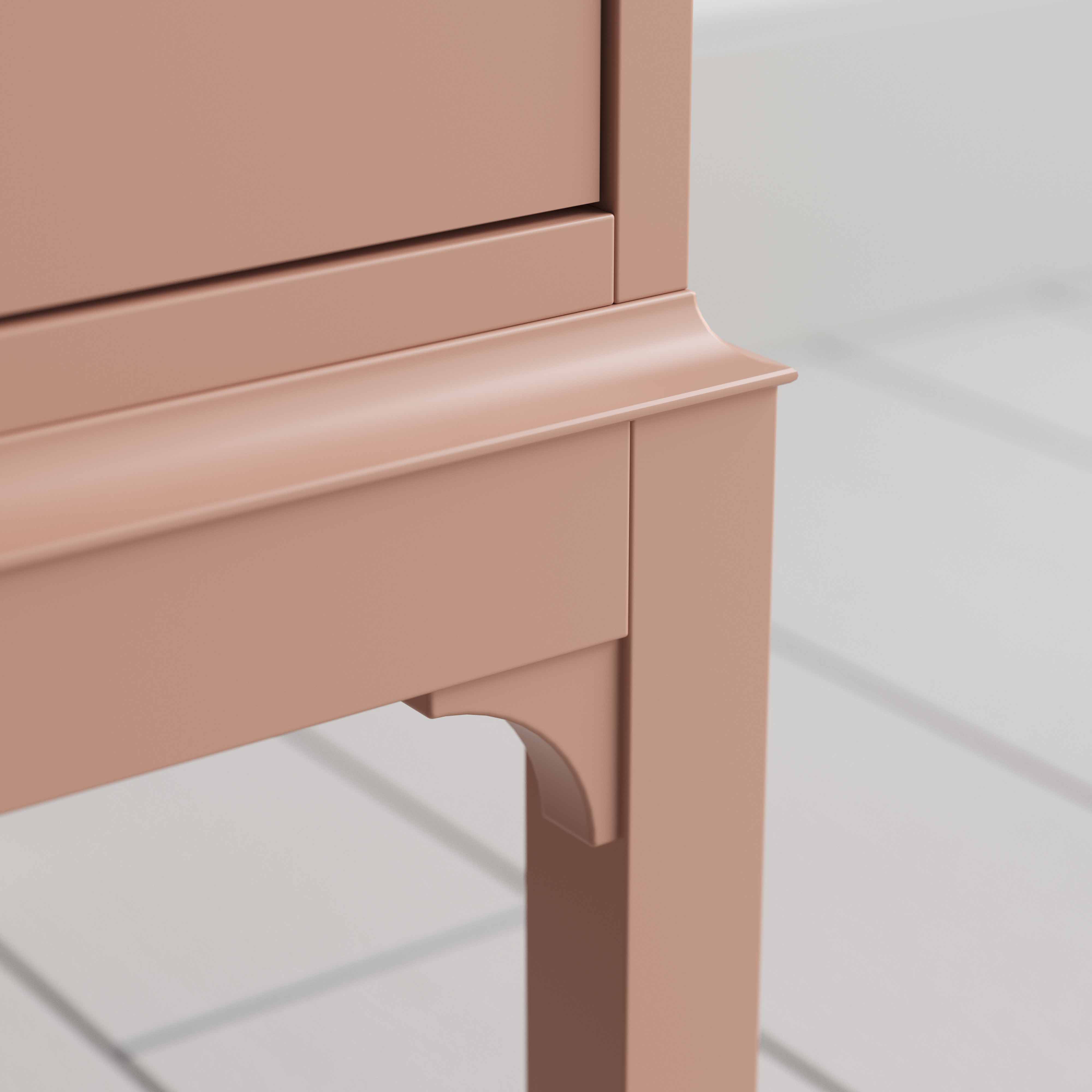 A close up of small pink bedside table with a side door, perfect for storing items