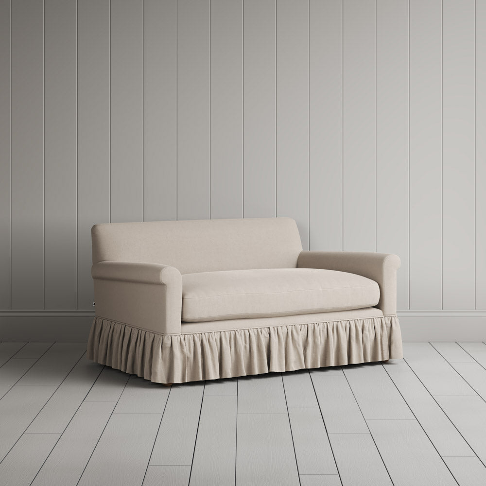 Angled shot of dove linen upholstered love seats by Nicola Harding.