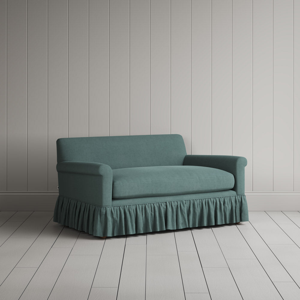 Angled shot of the Laidback Linen Mineral Curtain Call love seat by NiX.