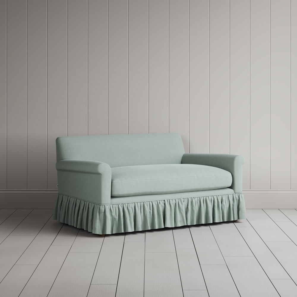 Three-quarter view of the Laidback Linen Sky Curtain Call love seat by NiX.