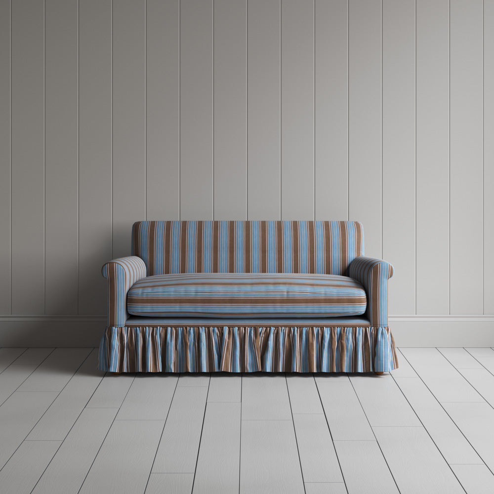 Front view of the blue cotton NiX sofa highlighting its gathered skirt base.