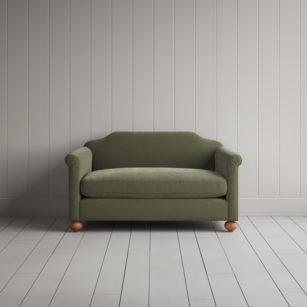 Front portrait of the green tea Dolittle love seat by Nicola Harding interiors.