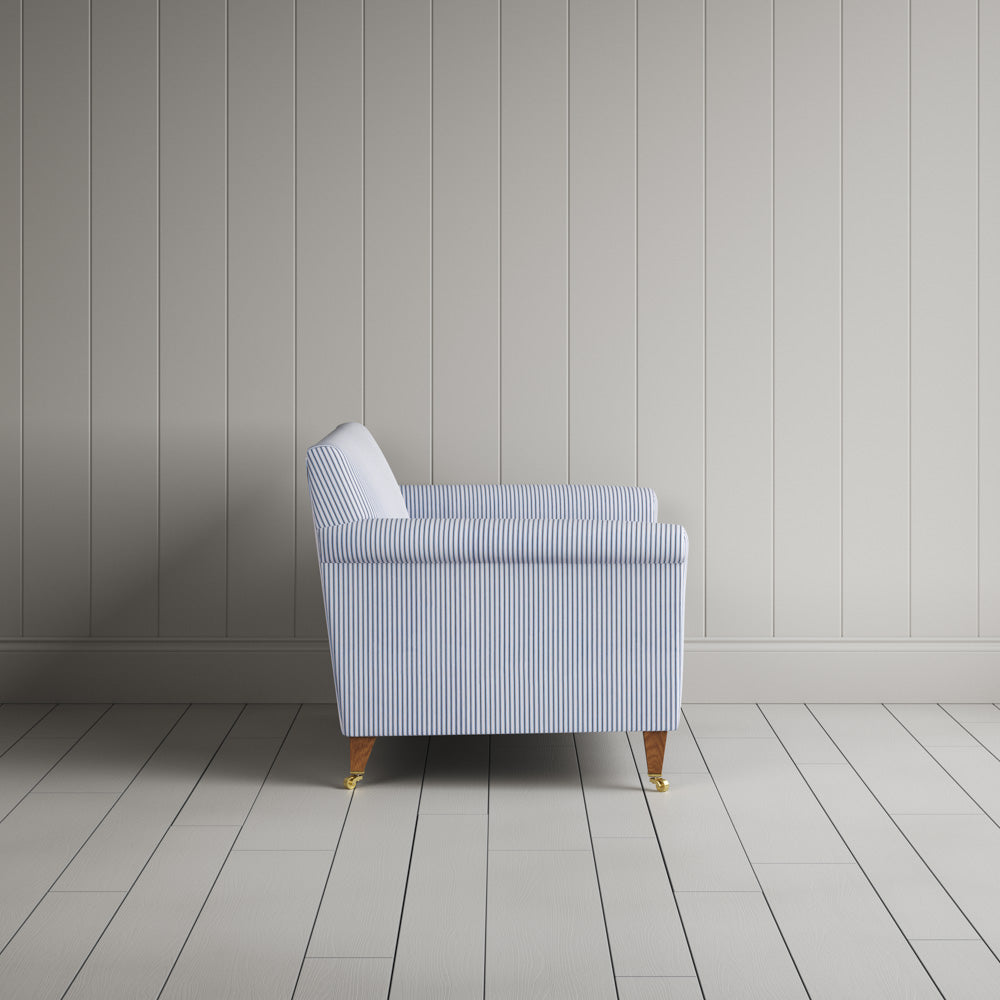 Side profile of the Idler seat in Aqua Brown ticking cotton by Nix.