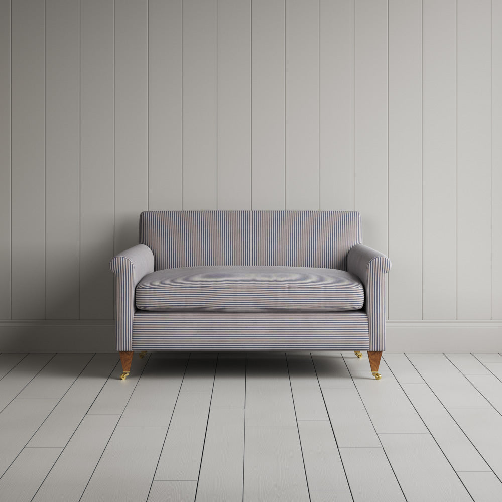 Symmetrical view of the ticking stripe Idler love seat featuring handmade British craftsmanship and refined upholstery by Nicola Harding.
