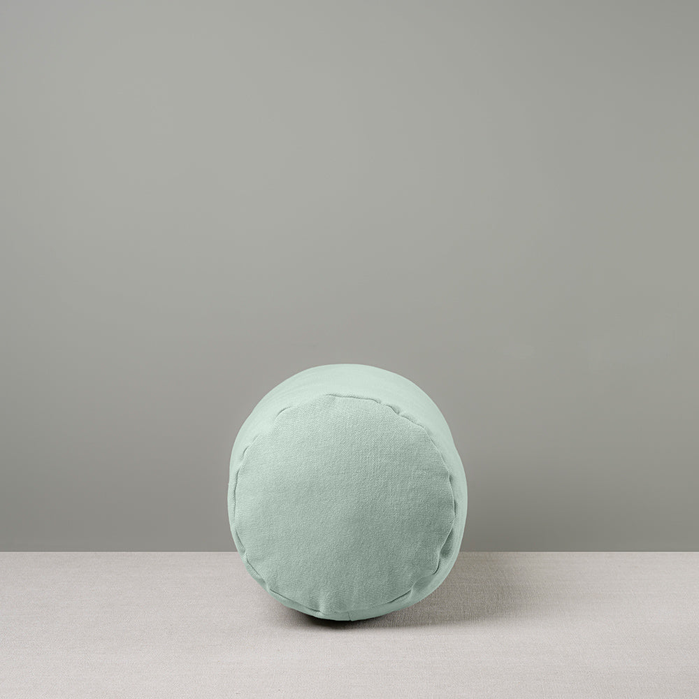 Side View of Bask Bolster Cushion in Laidback Linen, Sky - Nicola Harding