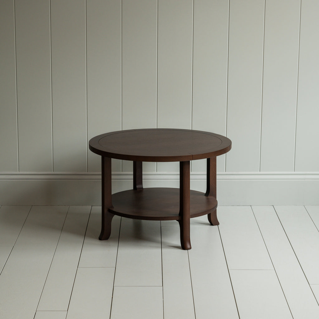 A circular wooden table with sturdy wooden base.