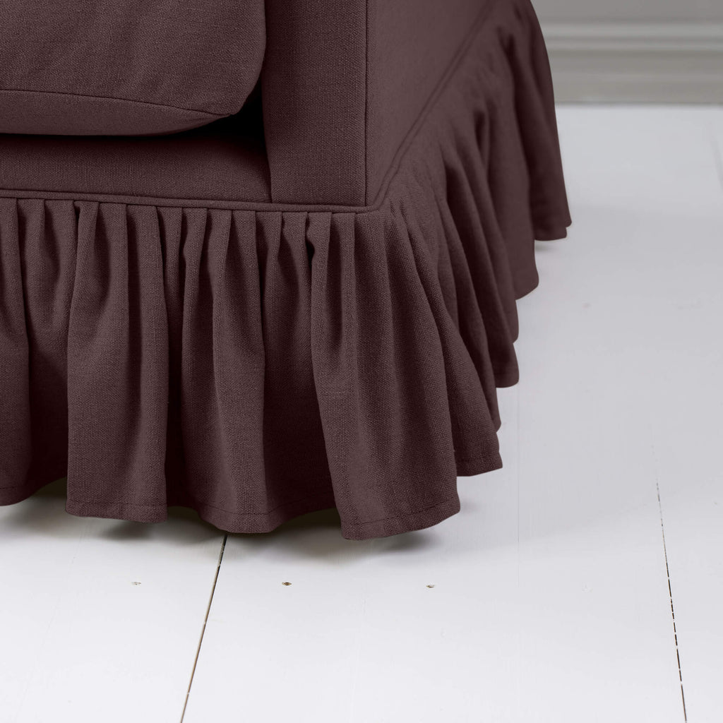 Curtain Call Love Seat close-up detail of the gathered ruffled skirt base in damson