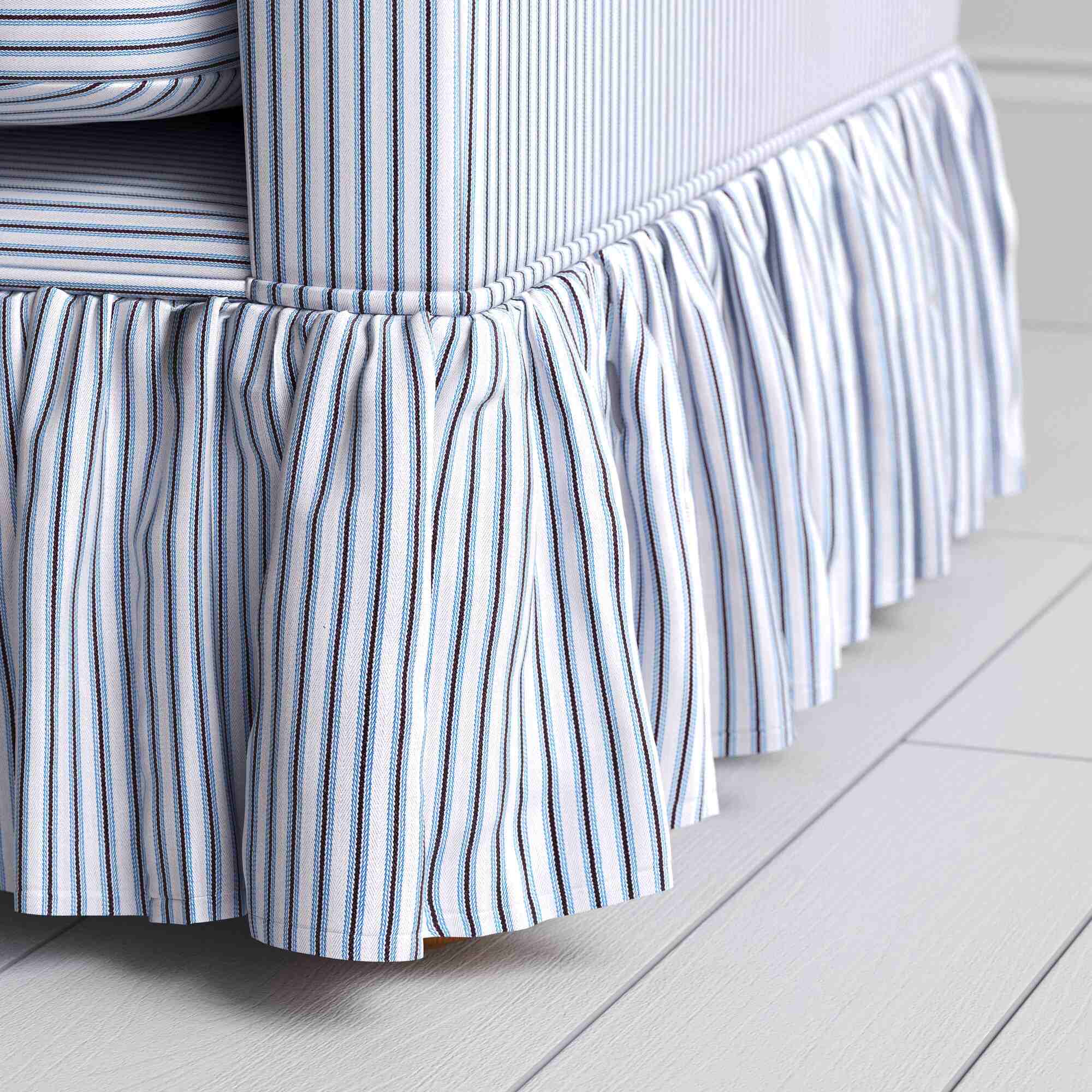 Detailed view of the gathered ruffle skirt and lower base on the Curtain Call sofa by NiX.