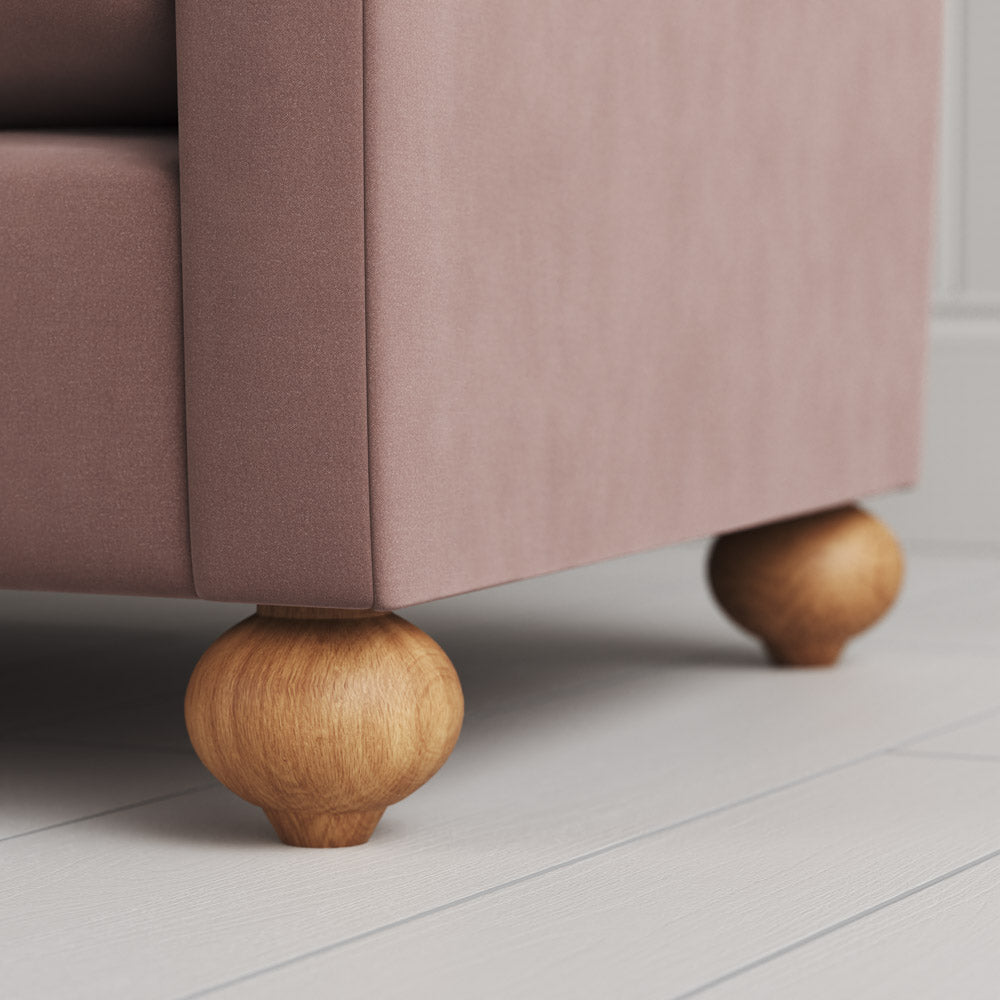 Zoomed shot of the solid wood feet on a Nicola Harding design sofa.