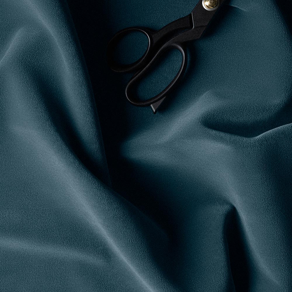 Velvet Aegean fabric in Blue color with scissors.