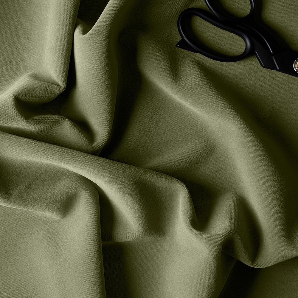 Velvet fabric in Green Tea color with scissors.