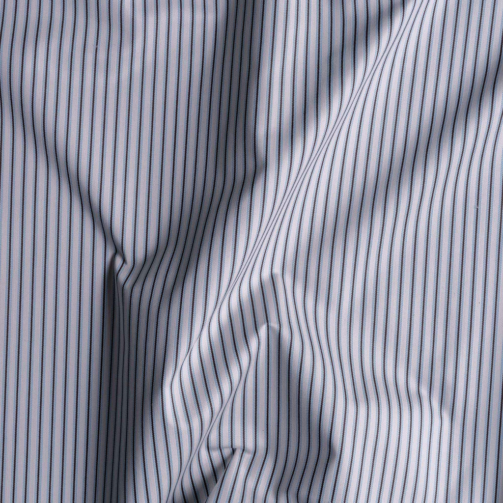 Close-up of folded ticking stripe cotton fabric by Nicola Harding.