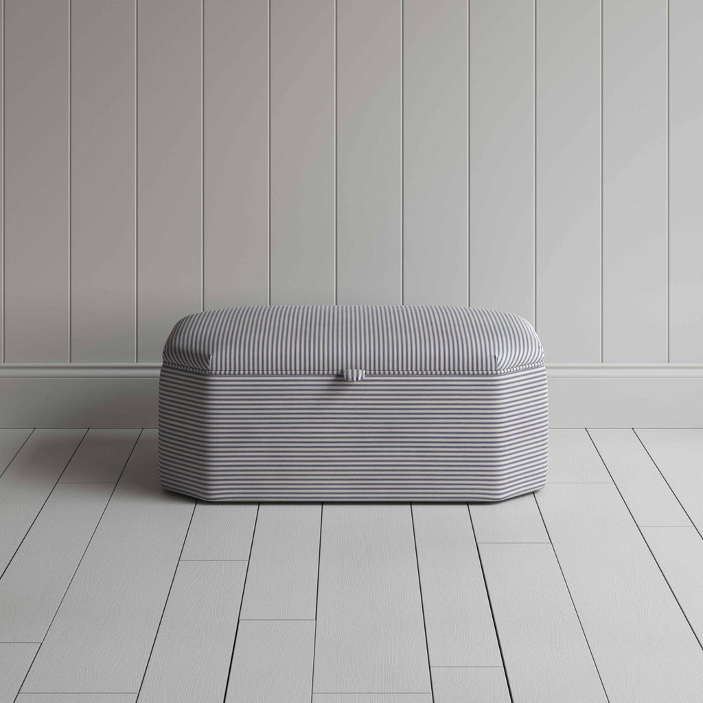 Stylish grey ottoman against white flooring. Front View - NiX