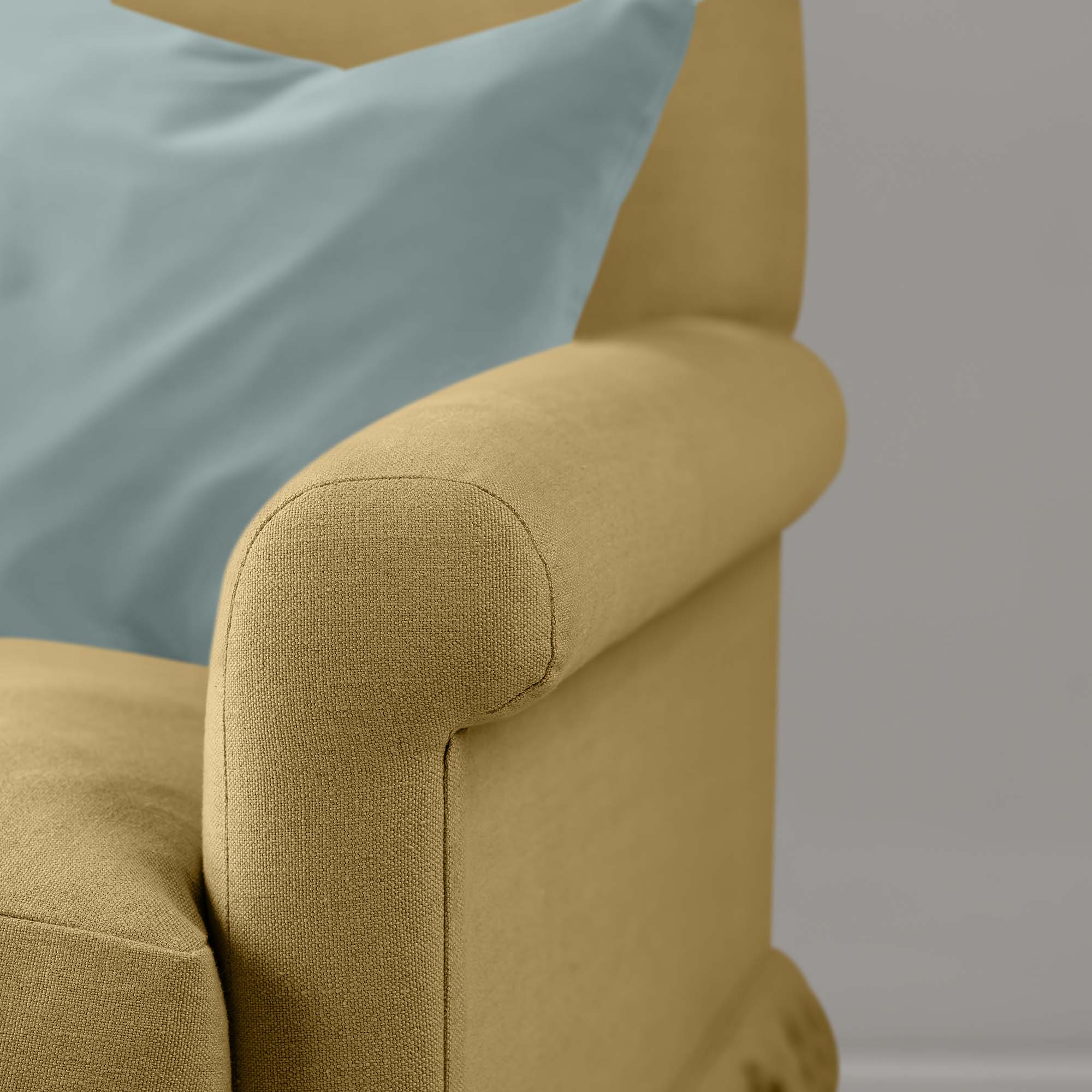Close-up of premium linen upholstery on a Nicola Harding love seat with a decorative accent cushion.