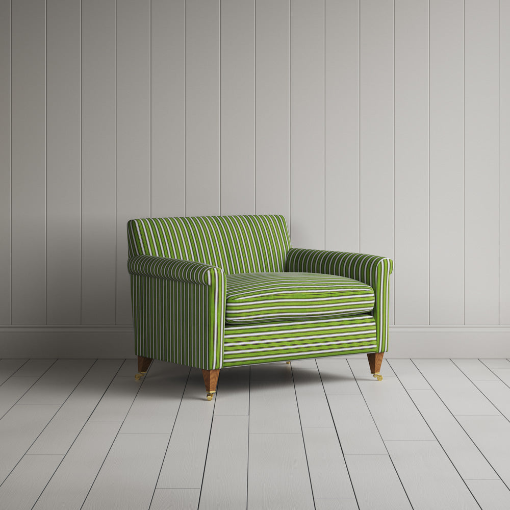 Striped green and white sofa by a wall.