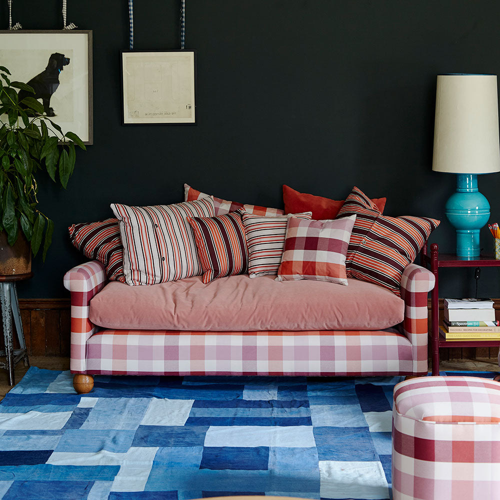 Elegant sofa in a beautifully designed living room, complemented with cushions by Nicola Harding & Co.