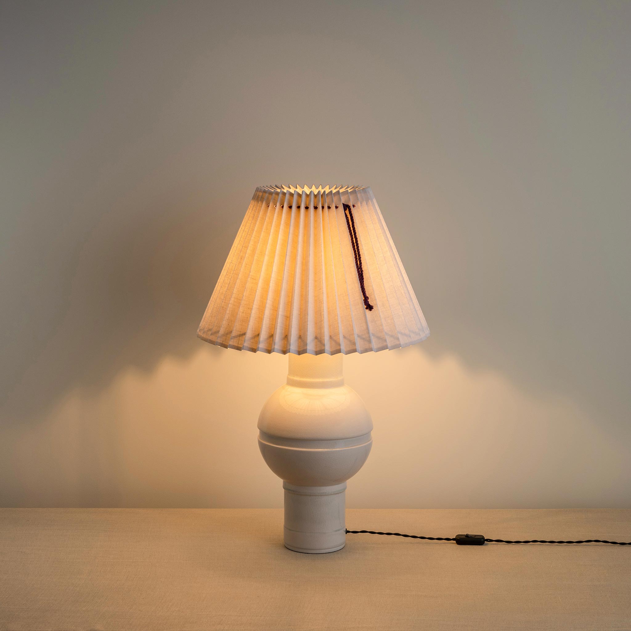 Orb Ceramic Table Lamp Base in Warm White, With Sunburst Concertina Natural Pleat Lamp Shade with Blackberry Cord, With Lights 'ON' - By NiX