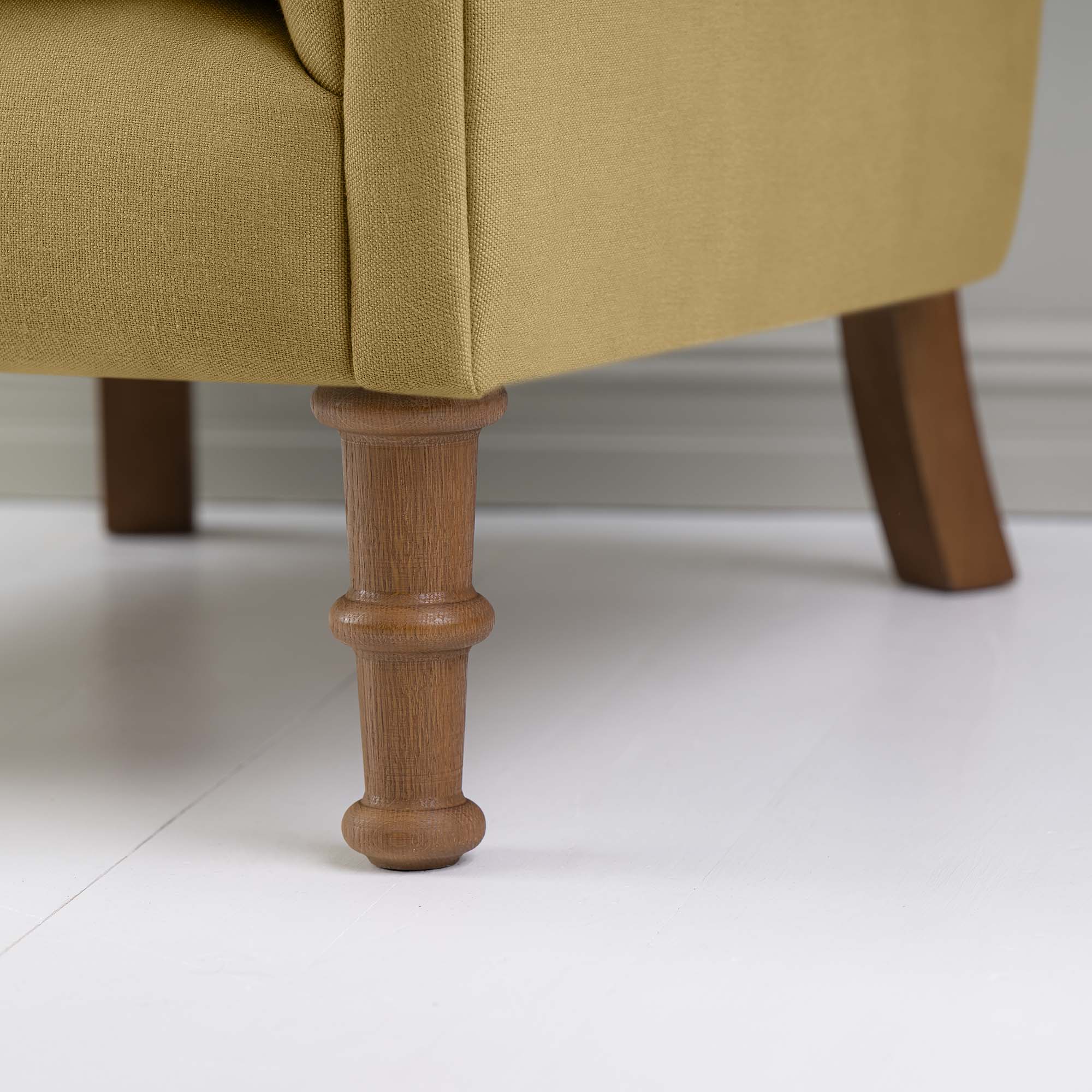 Time Out Armchair in Laidback Linen Ochre, Front Foot Design Closeup - NiX