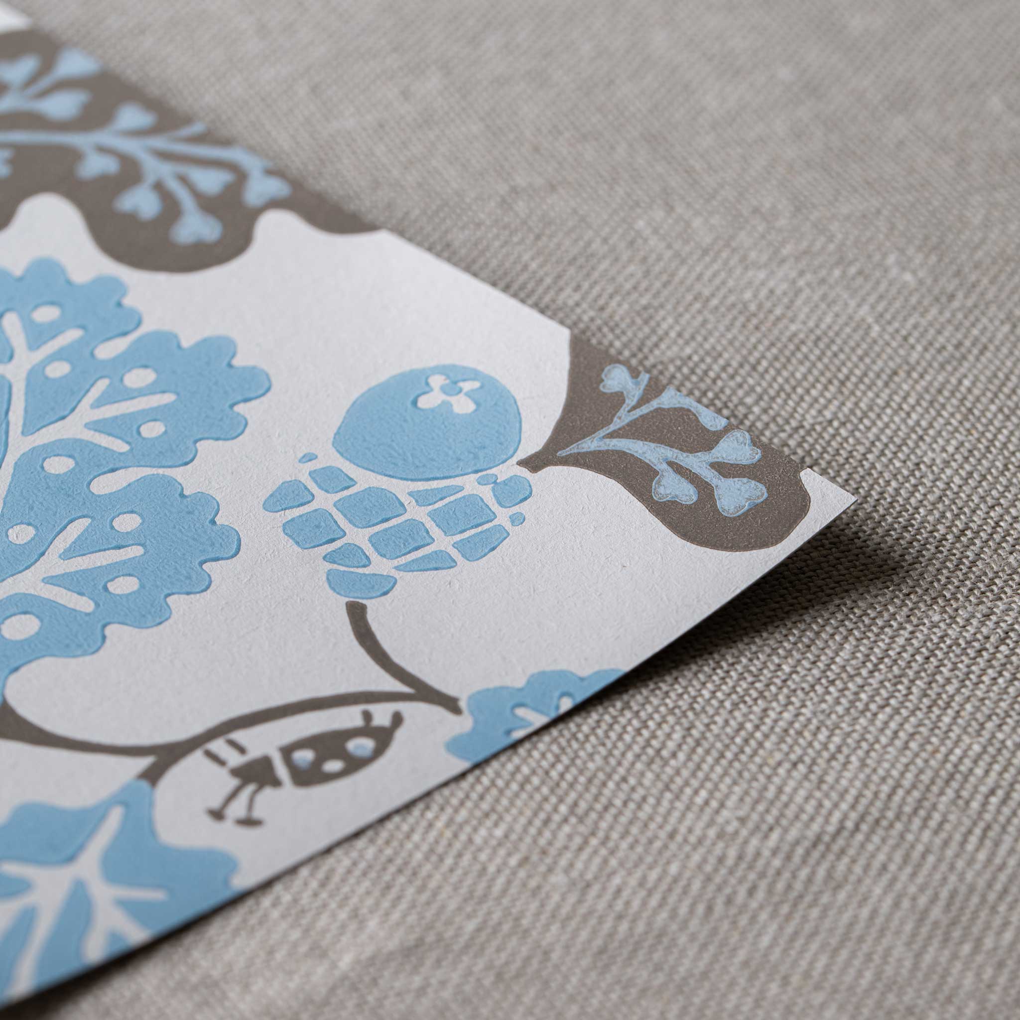 Neat edge of Acorn Wallpaper in Sugarbag Blue and Mushroom - Nicola Harding
