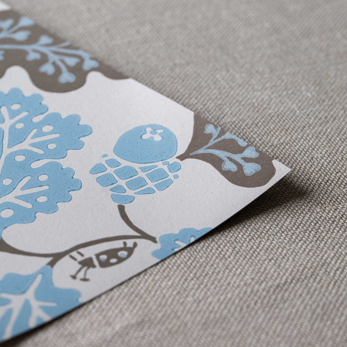 Neat edge of Acorn Wallpaper in Sugarbag Blue and Mushroom - Nicola Harding