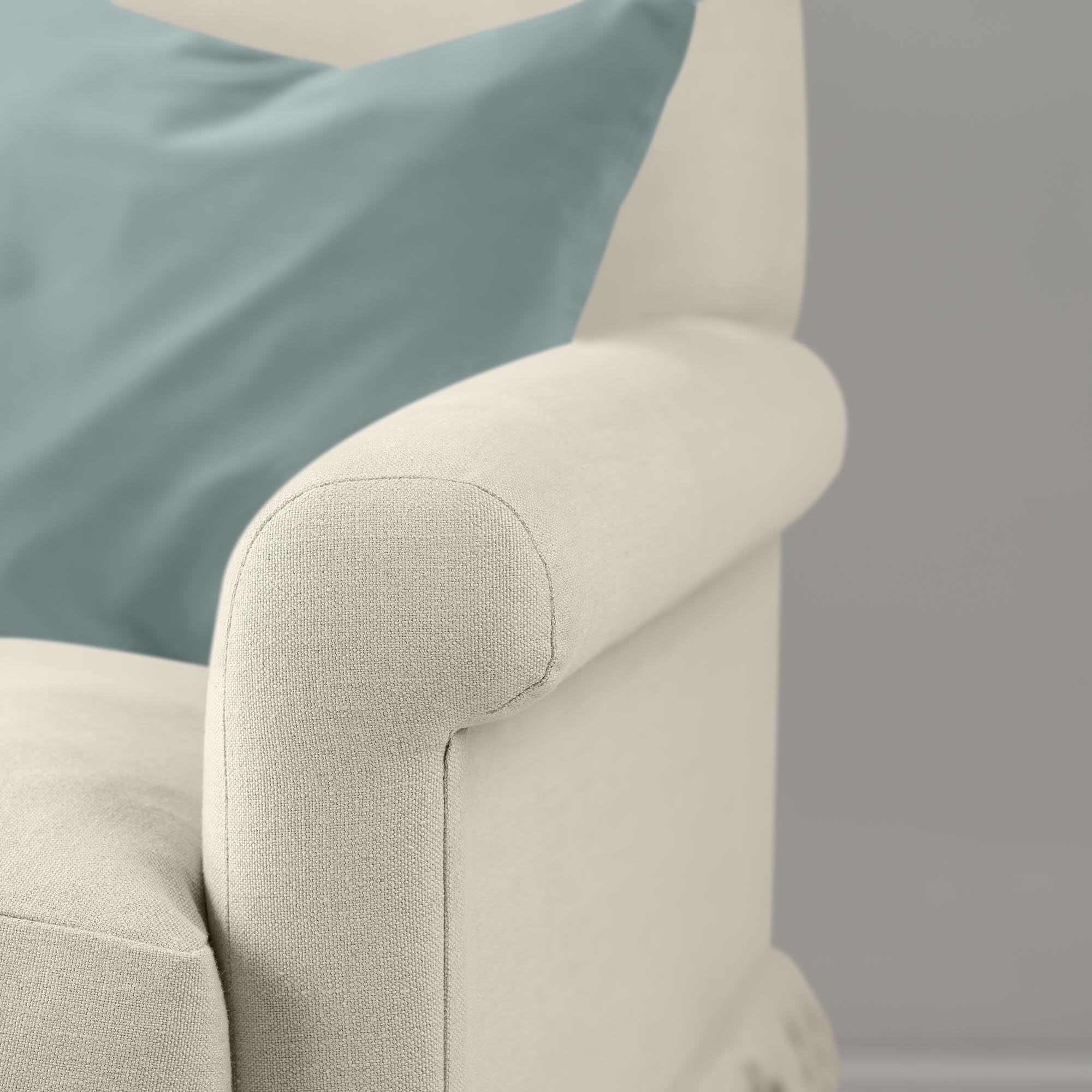  Detail of the armrest on the Dove Curtain Call sofa by NiX styled with a contrasting cushion. 