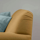 Curtain Call Love Seat close-up detail of the rounded backrest corner in laidback linen ochre.