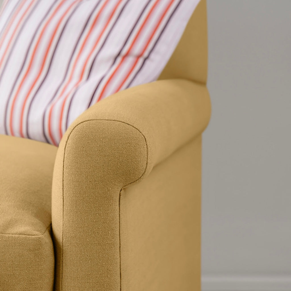  Detailed view of Ochre linen upholstery on the armrest by Nicola Harding. 