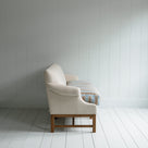 Side View of Front Row 3 Seater Upholstered Bench in Laidback Linen Dove Frame and Regatta Cotton Blue Seat -  By Nicola Harding & Co.