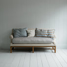 White couch on wooden floor in minimalist living room.