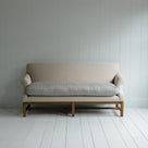 White couch on wooden floor in minimalist living room.