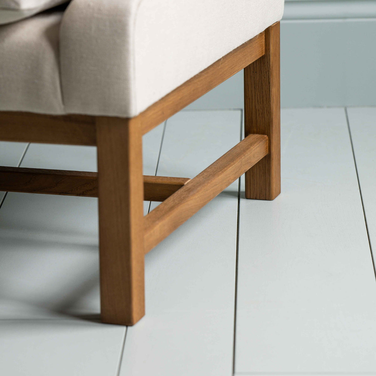 Frame Foot Design Closeup of Front Row 3 Seater Upholstered Bench in Laidback Linen Dove - Nicola Harding & Co.