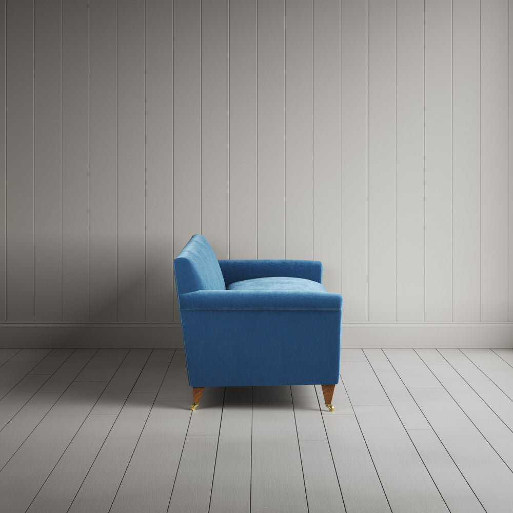  Side view of the Harbour Blue corduroy Idler sofa, perfect for a classic London drawing room. 