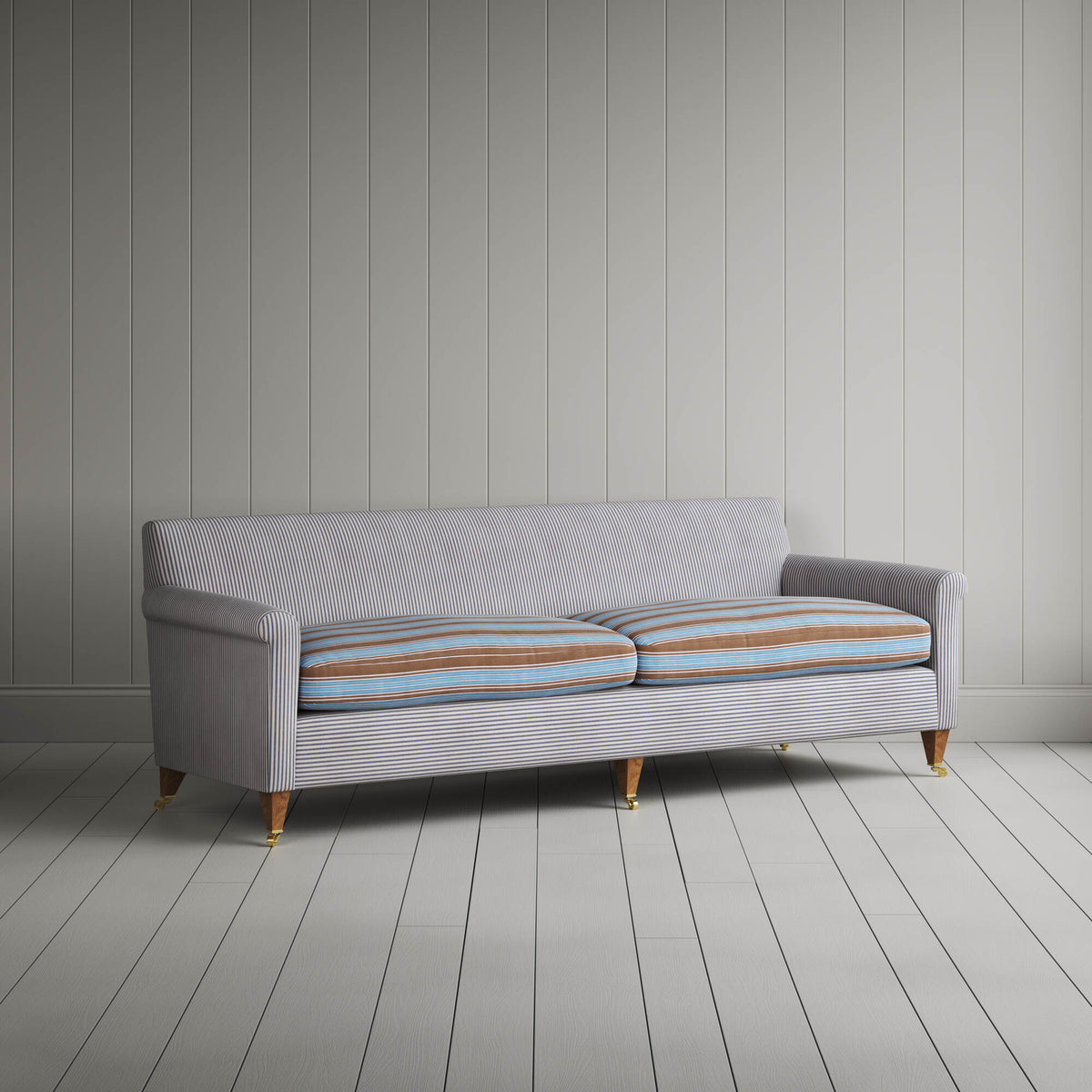 Angled view of the Ticking Blue Brown Idler sofa by NiX