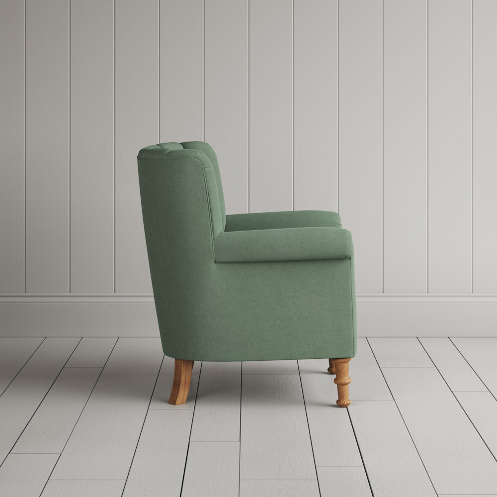  Time Out Armchair in laidback linen moss, side view by NiX. 