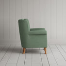 Time Out Armchair in laidback linen moss, side view by NiX.