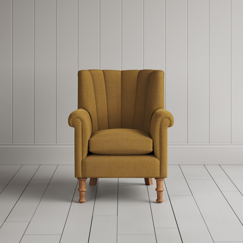 Time Out Armchair fluted back design in laidback linen ochre, front view by Nicola Harding.