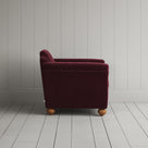 Side profile of the Cherry red corduroy Dolittle armchair - NiX