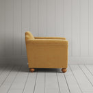 Side profile of the Wheat corduroy Dolittle armchair