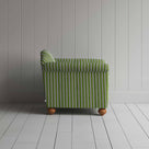 Green and white striped sofa against a wall.