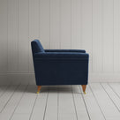 Side profile of the Dark Blue corduroy Idler armchair, featuring a simple Edwardian silhouette.