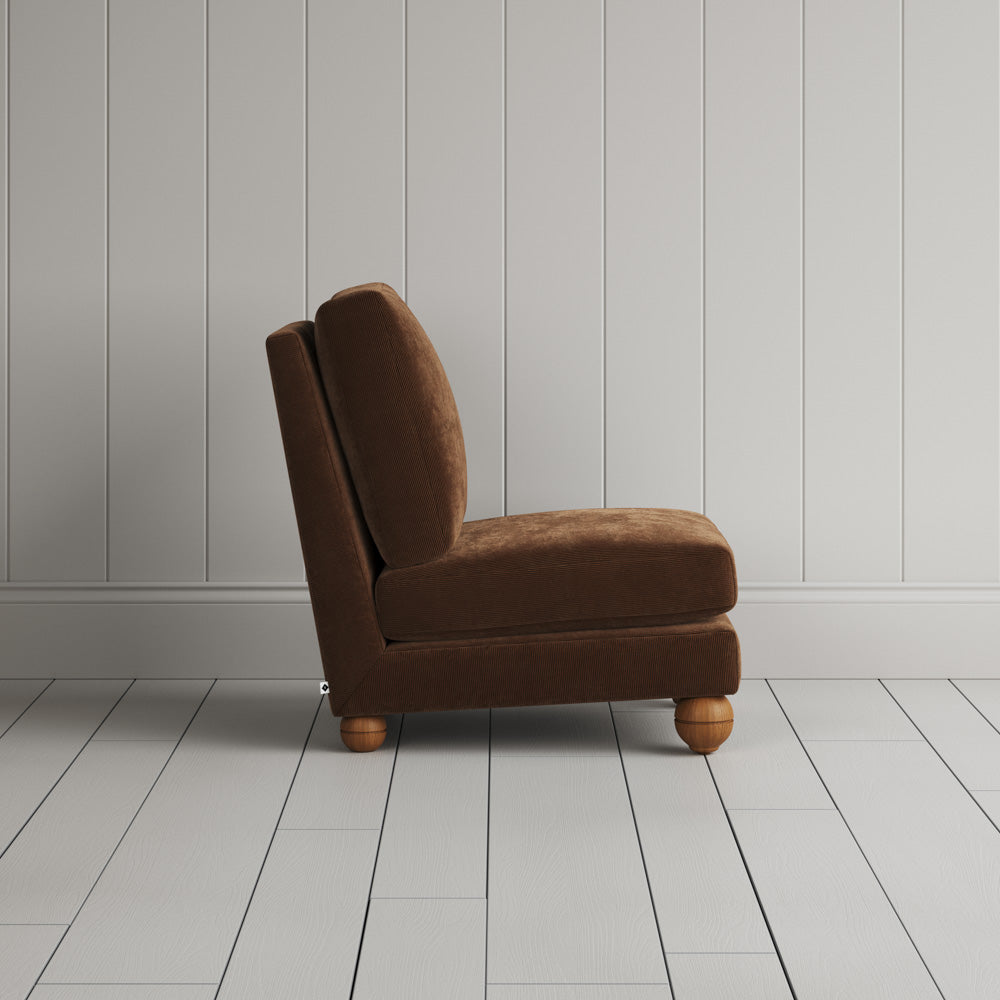 Side silhouette of the Perch slipper chair in Tobacco corduroy, perfect for awkward tight spots. 